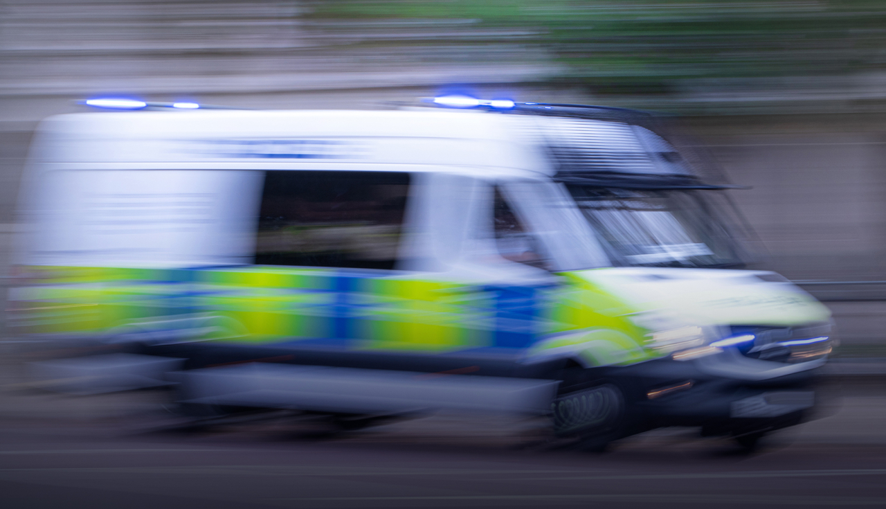 Blurred image of police van.