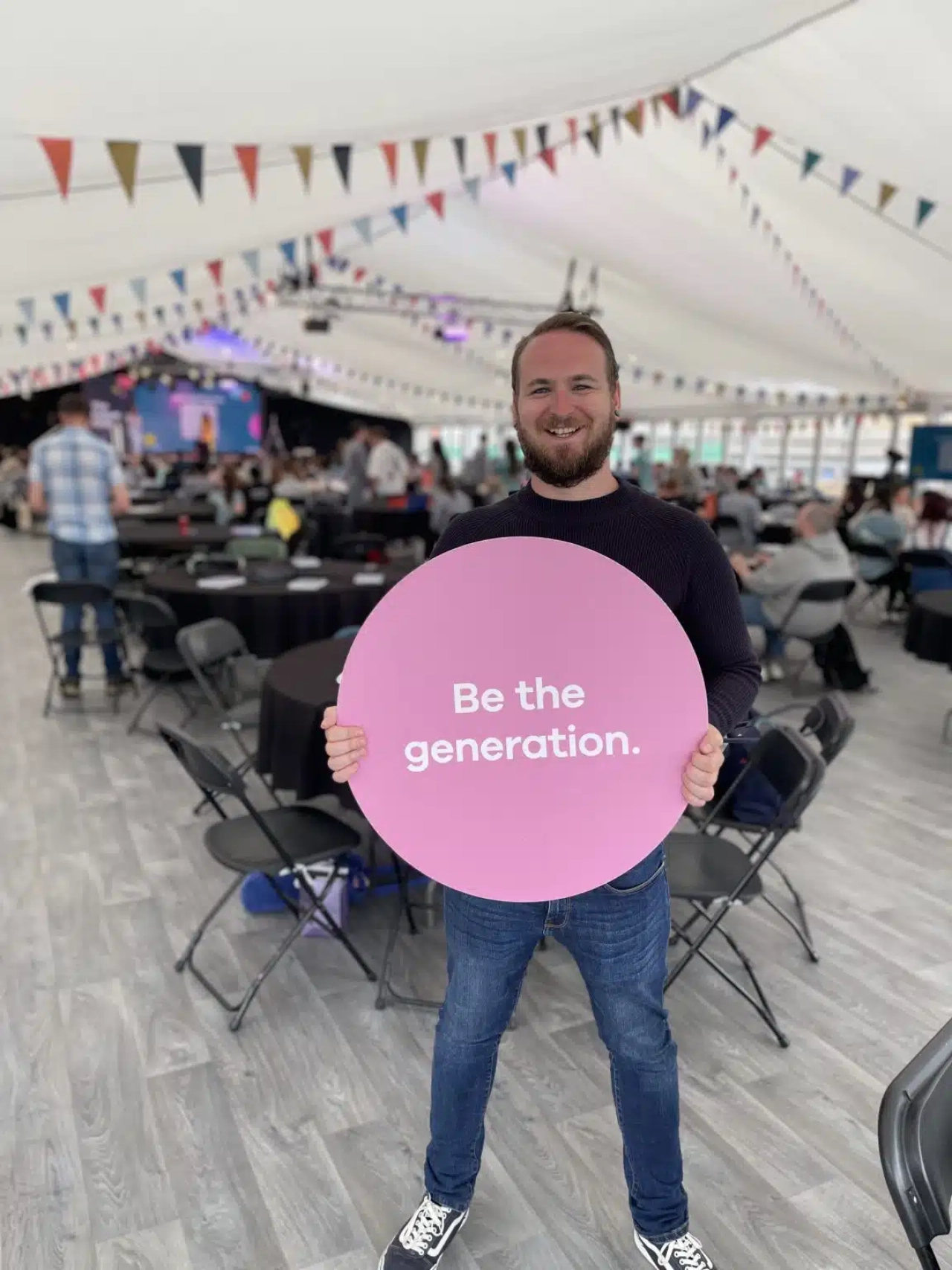 A man holding a sign saying