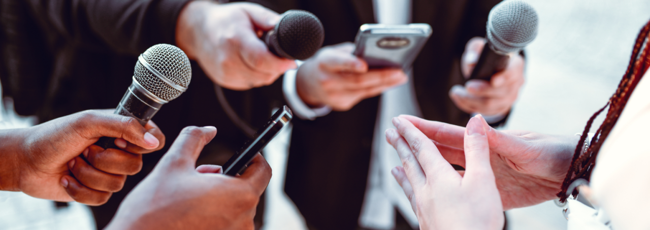 People conversing and using microphones to communicate with one another in a group setting.