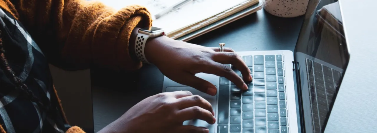 A person typing on a laptop computer.